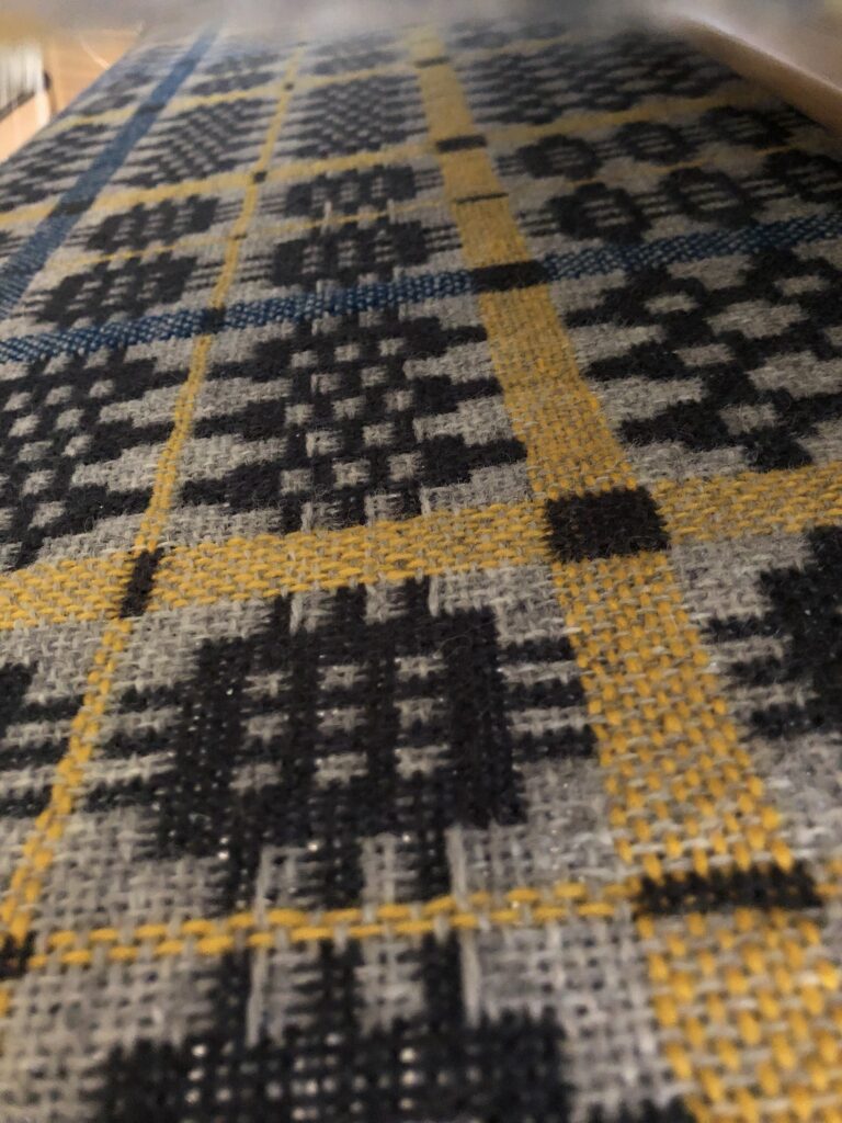 Close-up image of a Welsh blanket on the loom. Close-up image of a Welsh blanket on the loom.