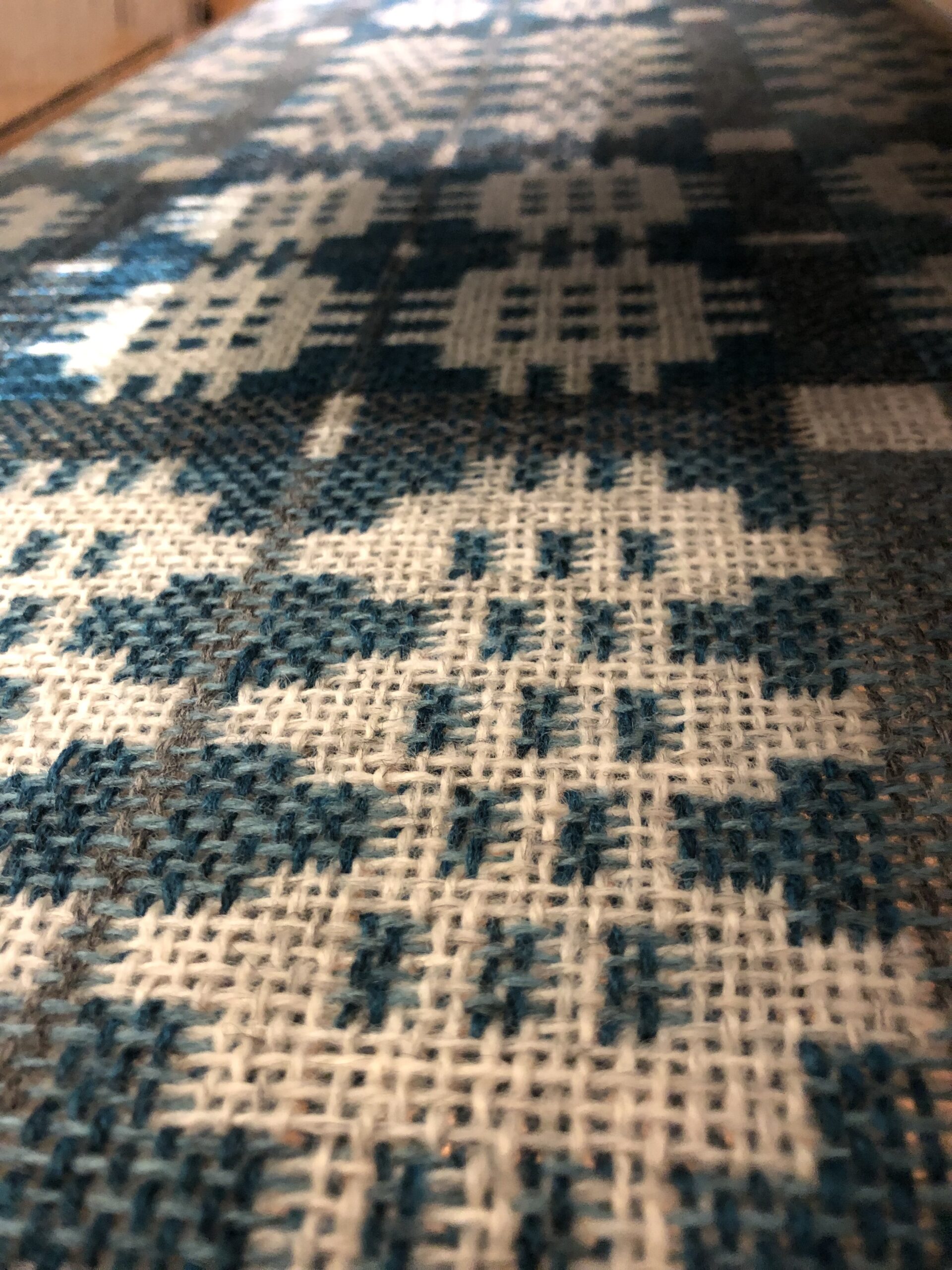 A peek between the layers of the blanket while weaving. A peek between the layers of the blanket while weaving.