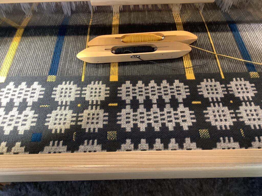 A traditional "Caernarfon" pattern Welsh blanket being woven on a loom. A traditional "Caernarfon" pattern Welsh blanket being woven on a loom.